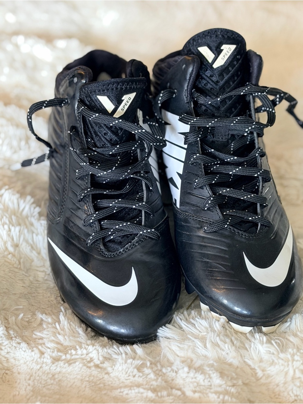 Nike Kids Black and White Athletic Cleats with Bold Swoosh